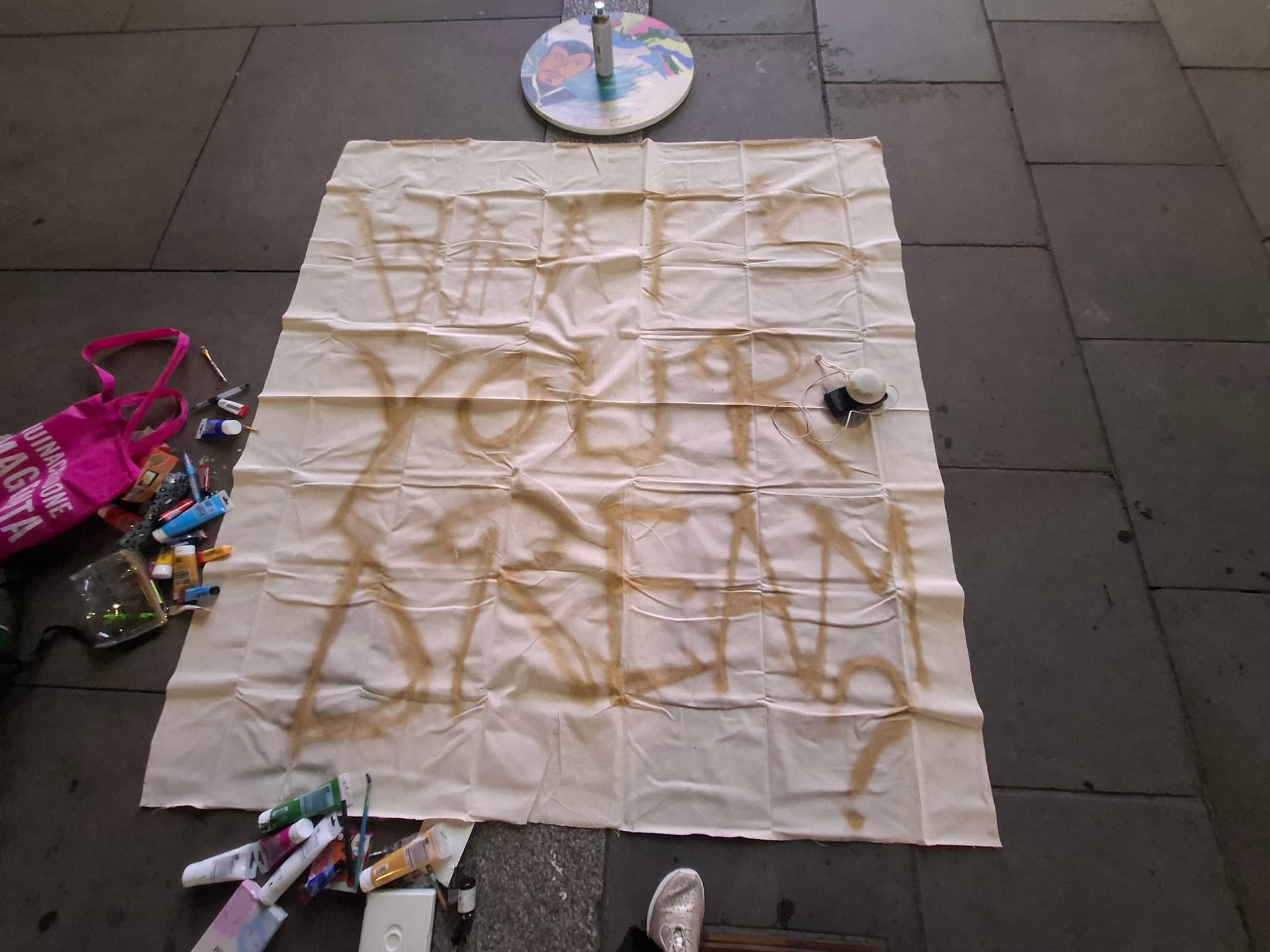 The words 'What is your dream?' painted across a canvas on the street
