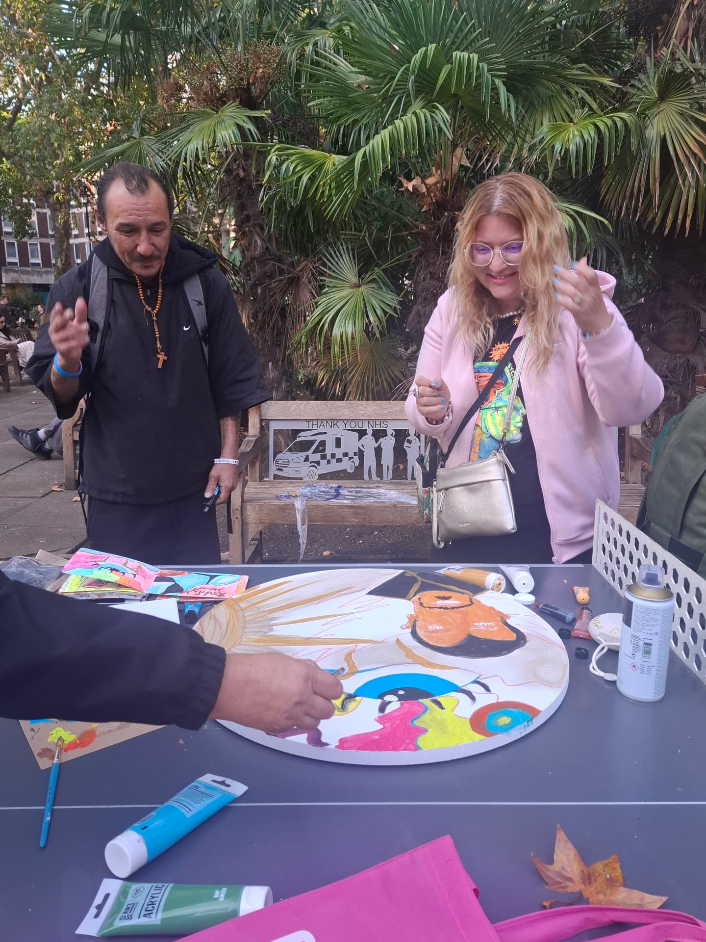 Painting together at an outdoor table in a London square